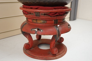 A large Japanese bronze temple bowl with beater, on red lacquered stand. Bowl 33cm diameter. Condition - fair to good